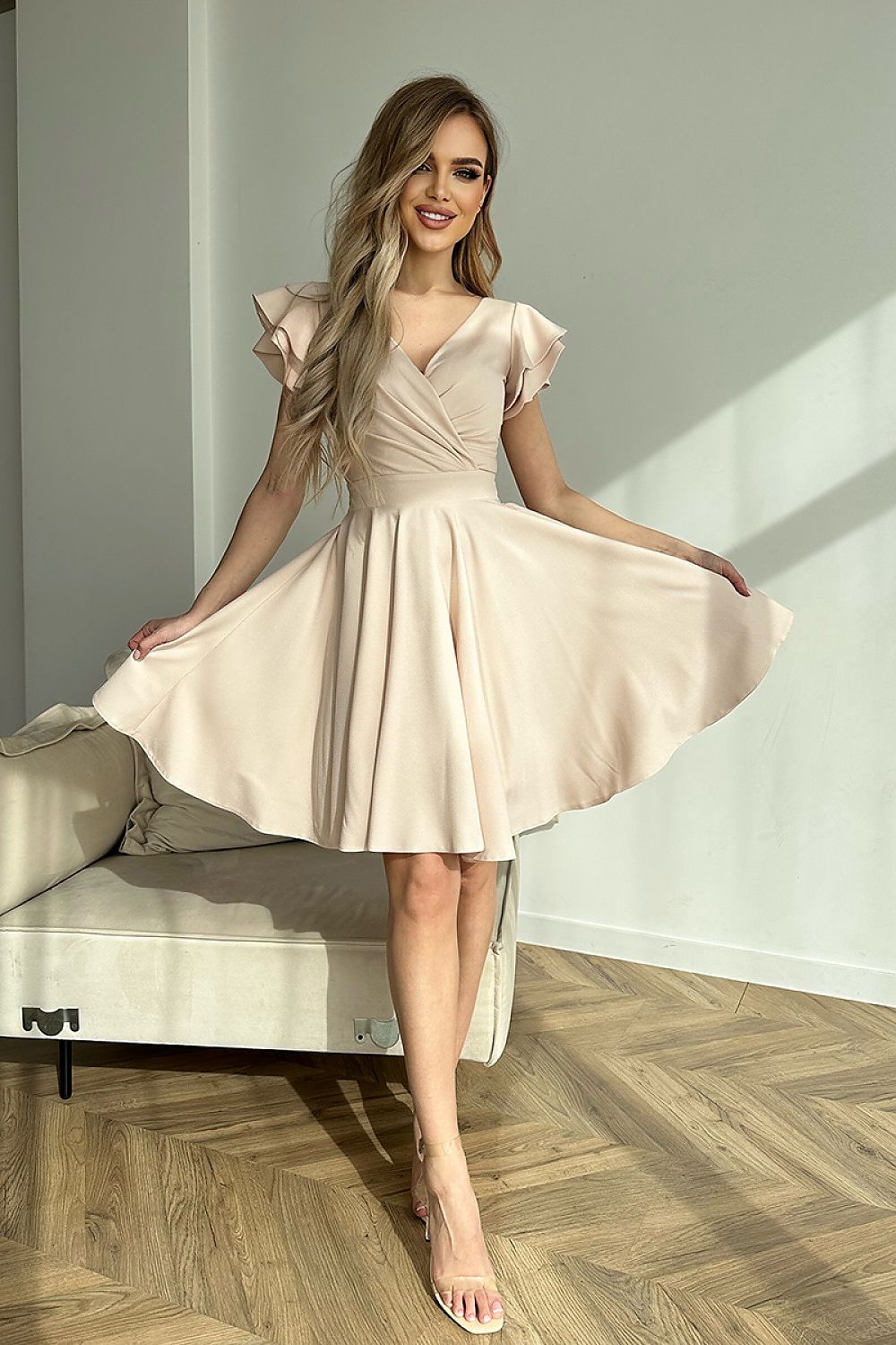 Vrouw in Ruffle Charm taillejurk met ruches aan de mouwen – elegante meisjesachtige jurk